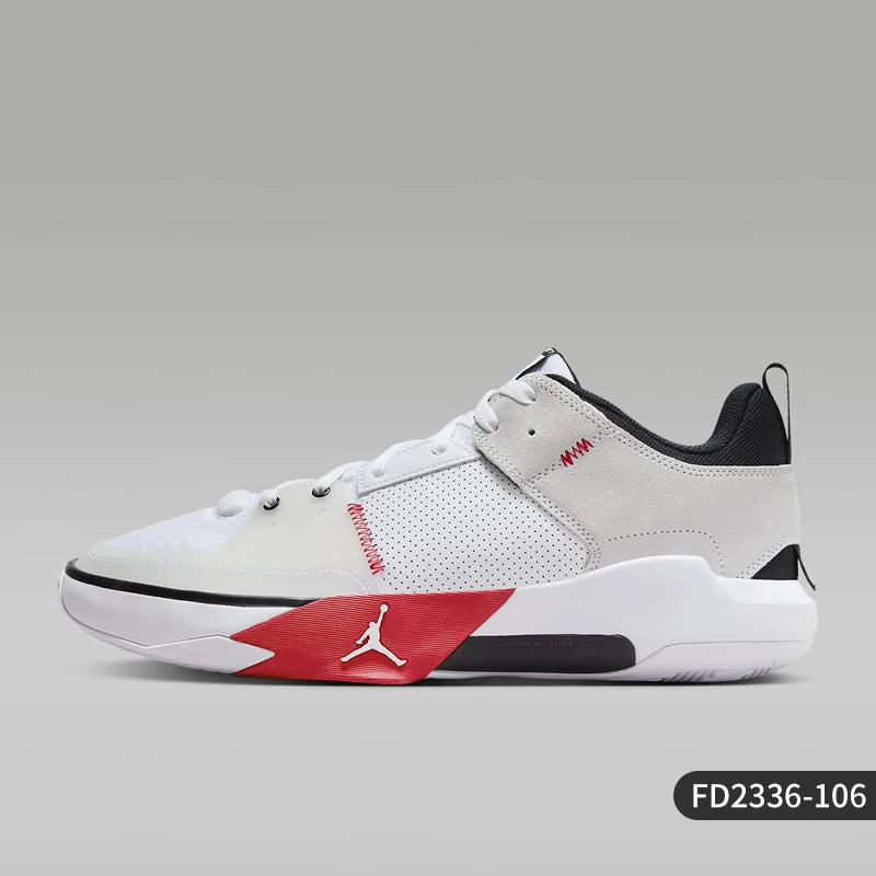 White sneaker with red and black accents on a gray background